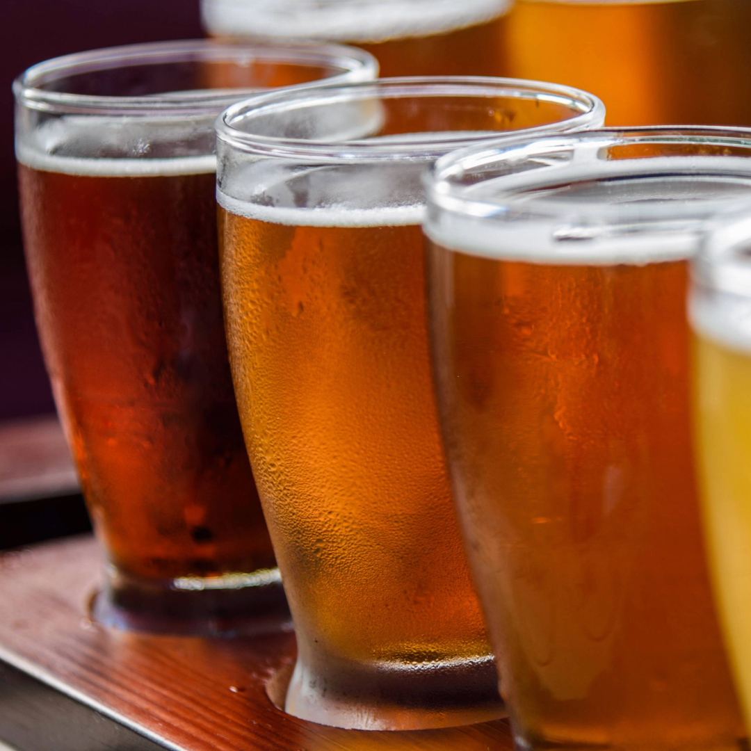 a line of glasses filled with beer