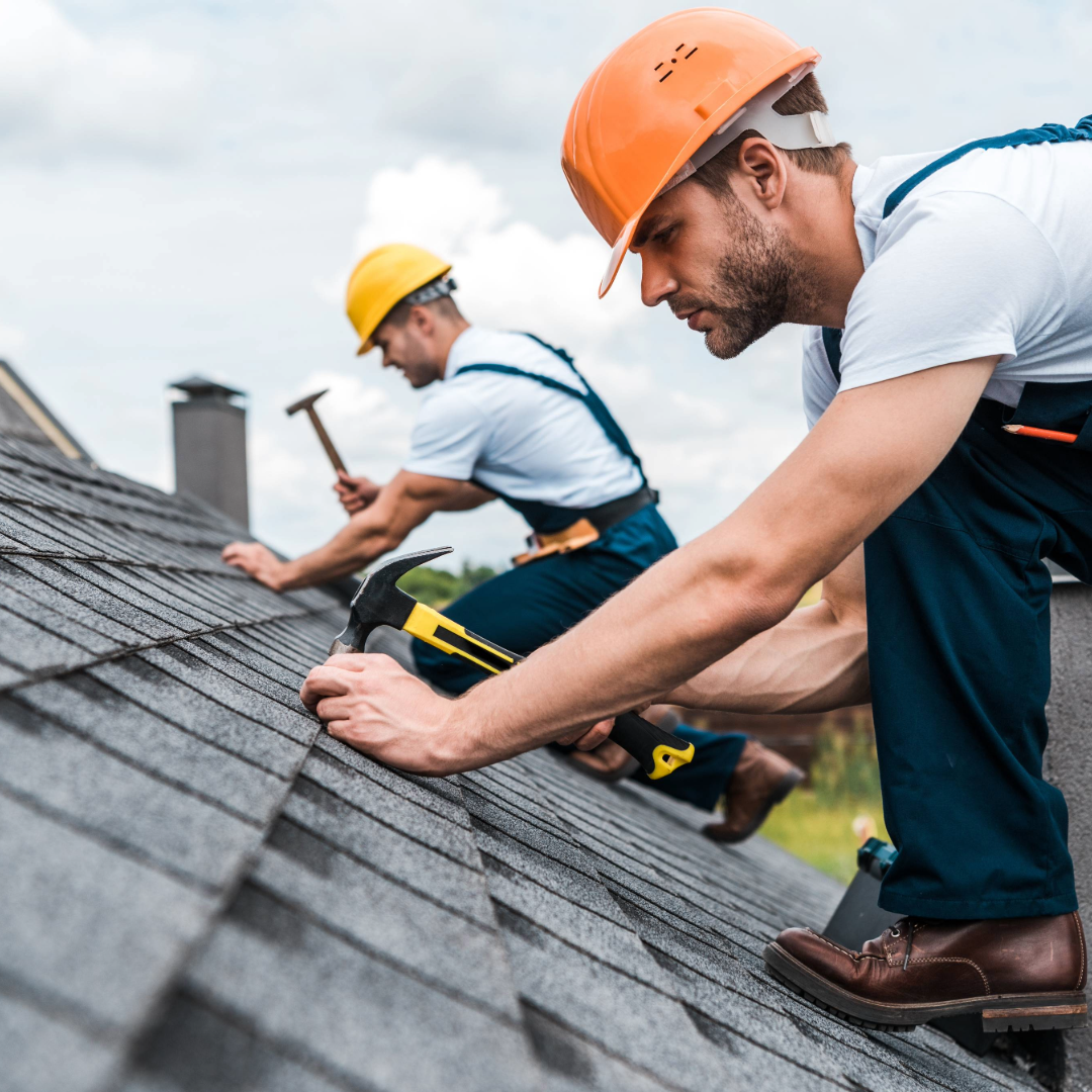 two men fixing a roof 