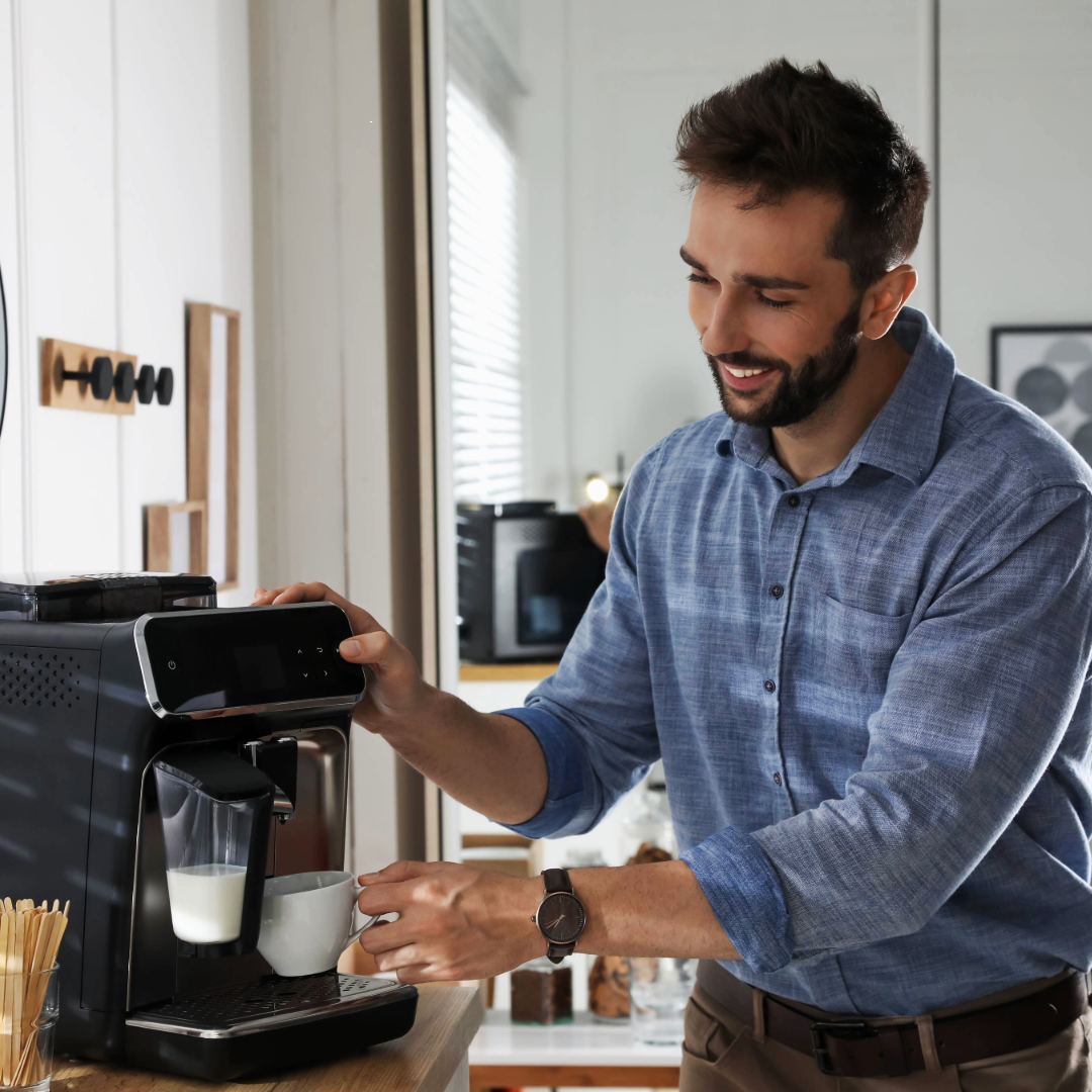 a man using a coffee machine 