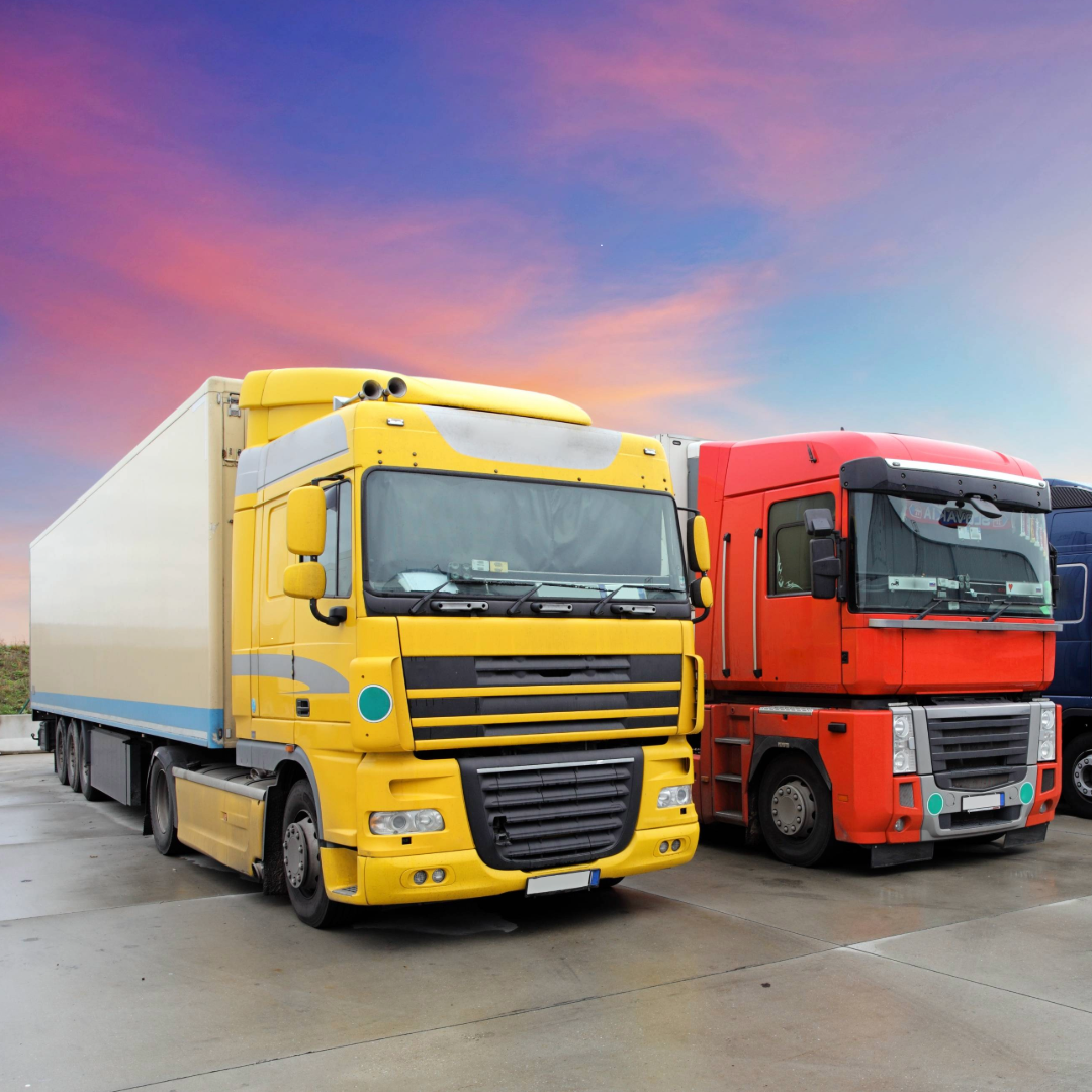 a yellow and red truck parked on the road 