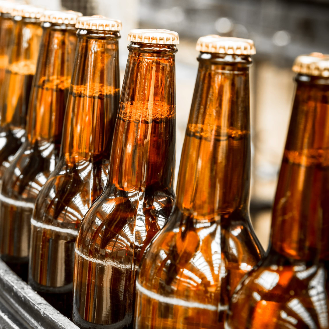 a line of brown glassed beer bottles 