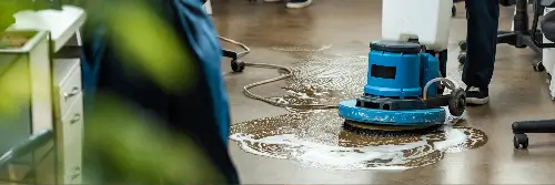 Person cleaning floor with machine