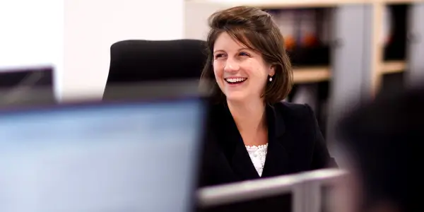 Businesswoman smiling while looking to her side in an office