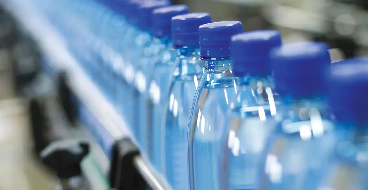 Water bottles moving along a conveyor belt in a factory