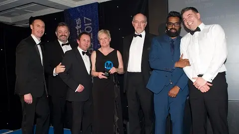 Close Brothers employees posing with a Business Moneyfacts award