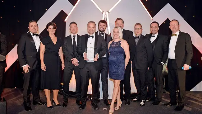 Group of people from Close Brothers posing with an award