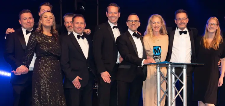 Group of people on stage accepting a Business Moneyfacts award