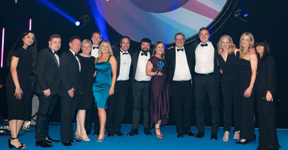 Group of men and women posing for a photo after winning at the Business Moneyfacts Awards