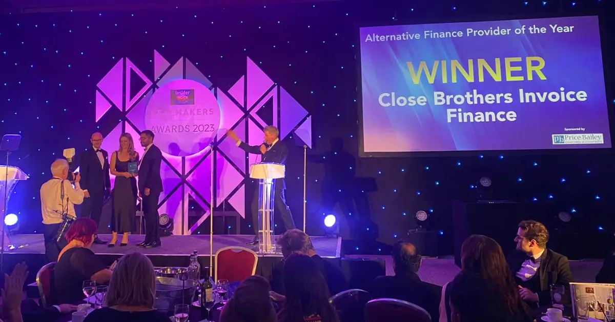 Three people on stage accepting the award for Alternative Finance Provider of the Year